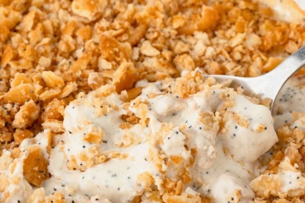 "Close-up of poppy seed chicken casserole on a spoon.