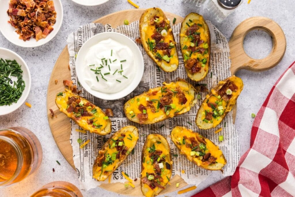 Potato skins on a wooden board.