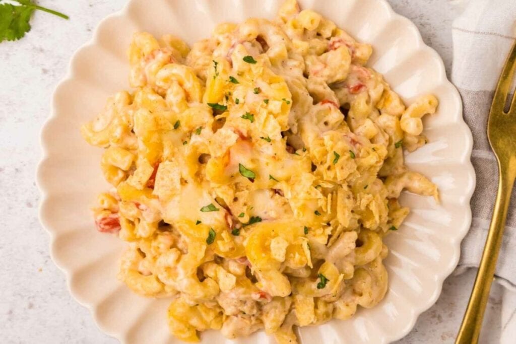 Queso mac and cheese on a white plate.