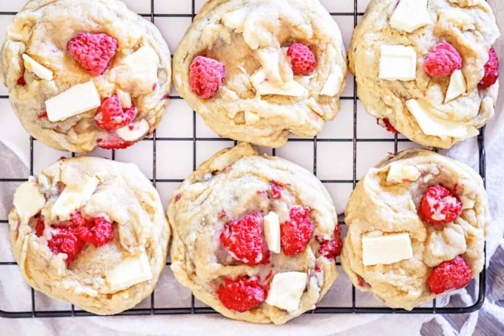 Raspberry white chocolate cookies on a cooling rack.
