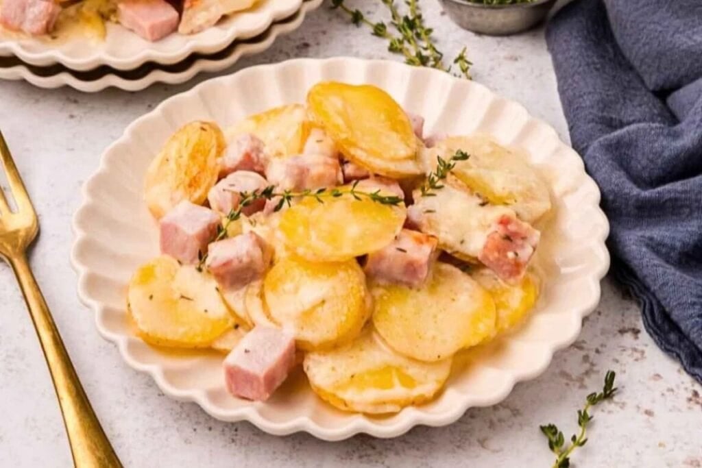 Scalloped potatoes and ham on a plate.