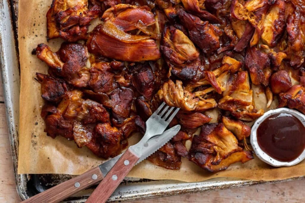 Slow cooker bbq chicken thighs on a sheet pan.