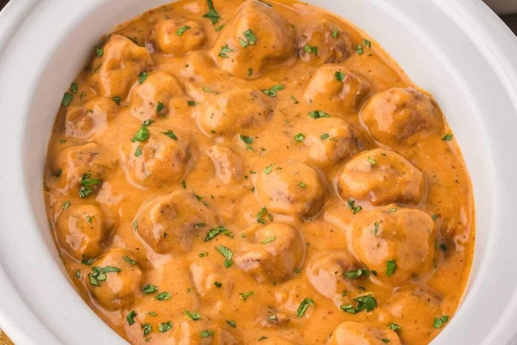Butter chicken meatballs in a slow cooker.