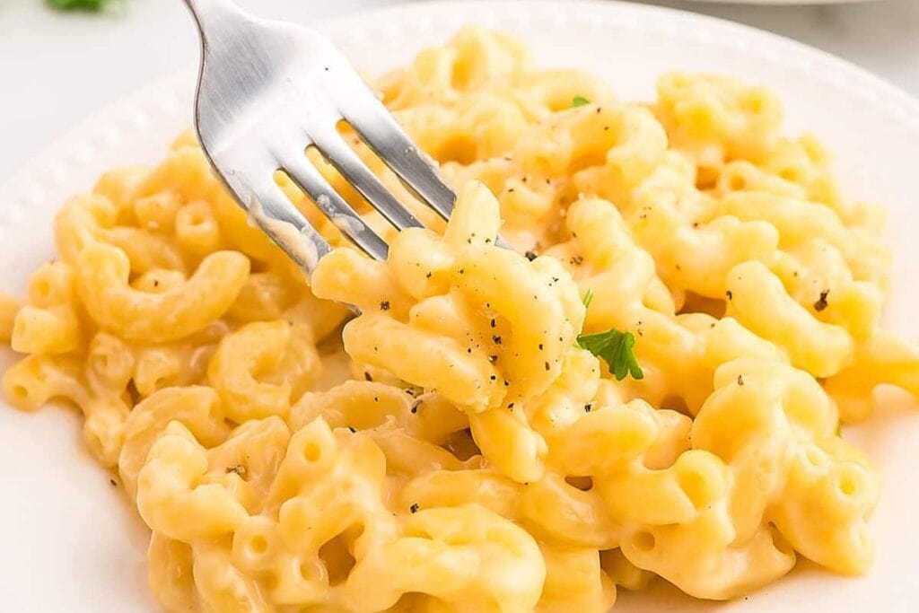 Close-up of smoked gouda mac and cheese on a plate with a fork.