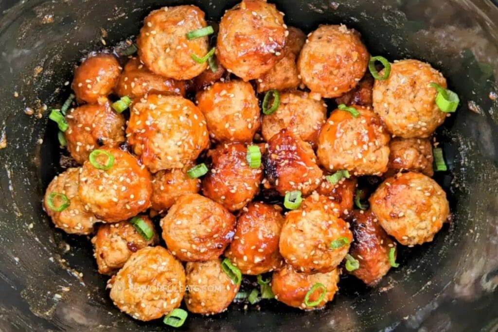 Spicy Korean meatballs in sauce inside a slow cooker.