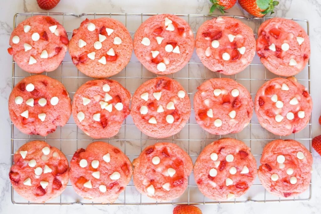 Strawberry white chocolate chip cookies on a cooling rack.