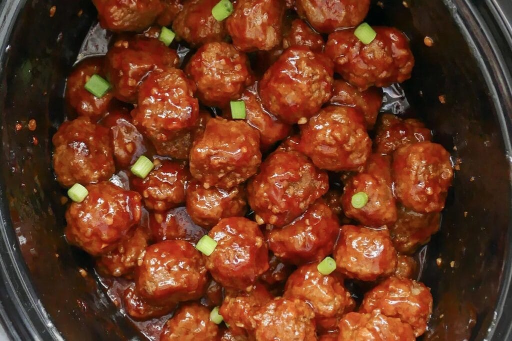 Sweet and spicy meatballs in a crockpot.