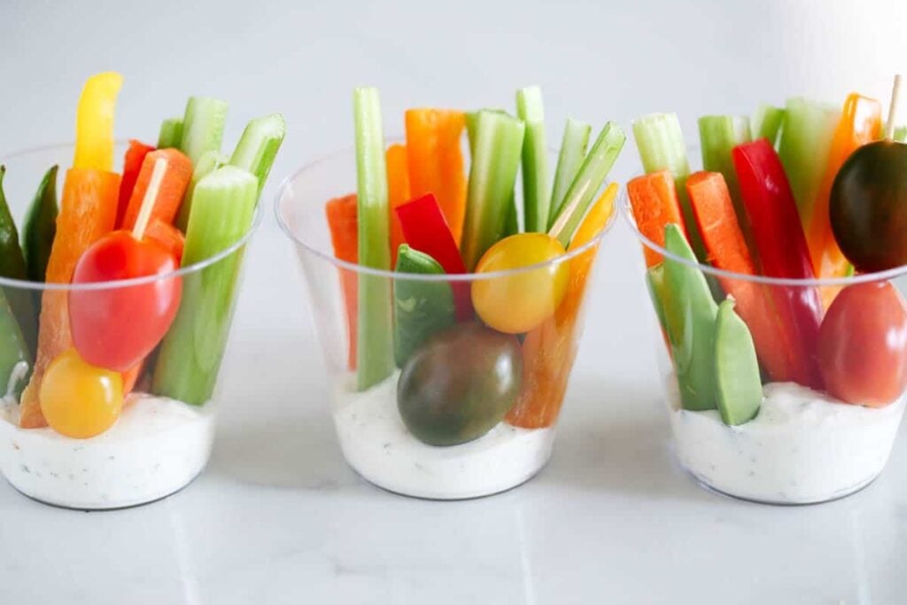 Colorful veggie cups with assorted fresh vegetables.