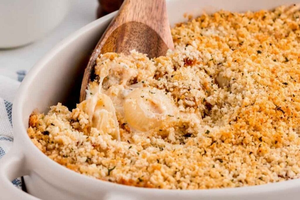 Vidalia onion casserole in a baking dish with a wooden spoon.