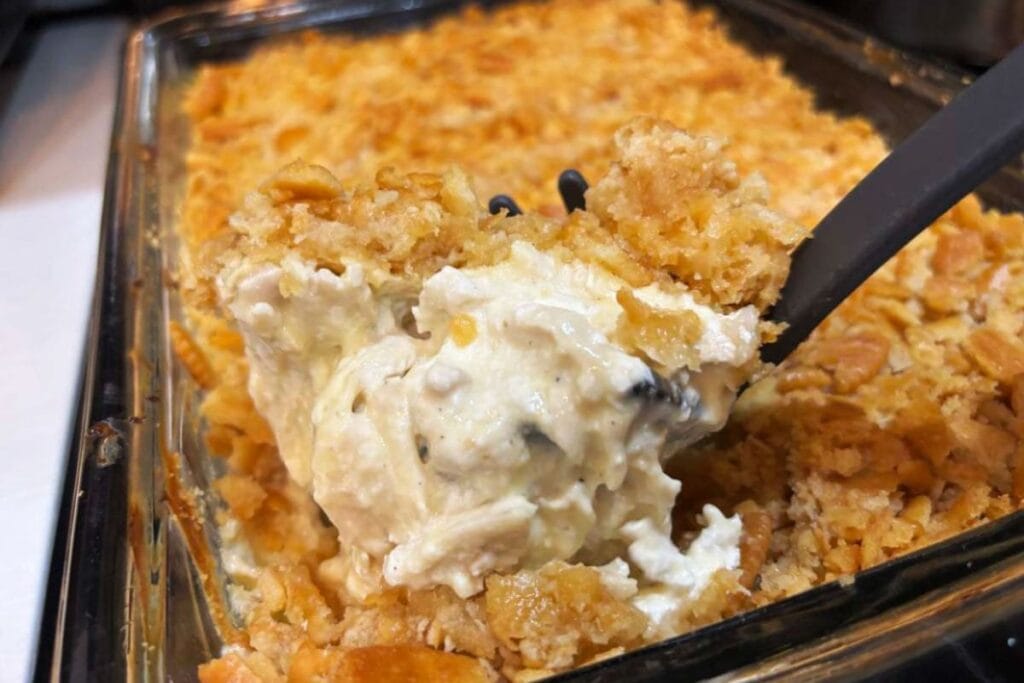 Chicken casserole with a cornflake topping in a glass baking dish.