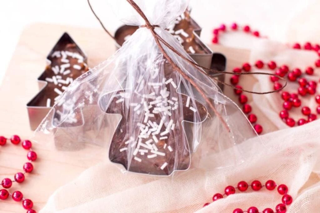 Christmas tree and gingerbread man fudge in wrappers with sprinkles.