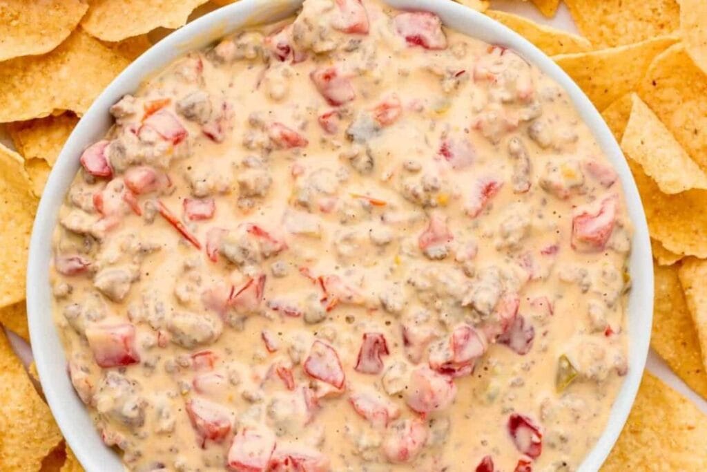 Cream cheese sausage dip with diced tomatoes and tortilla chips.
