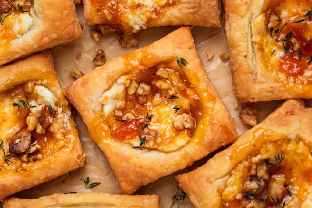 Square puff pastries with goat cheese, apricot jam, and walnuts.