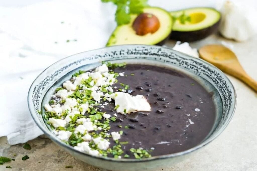Black bean soup with cheese, cream, and avocado.