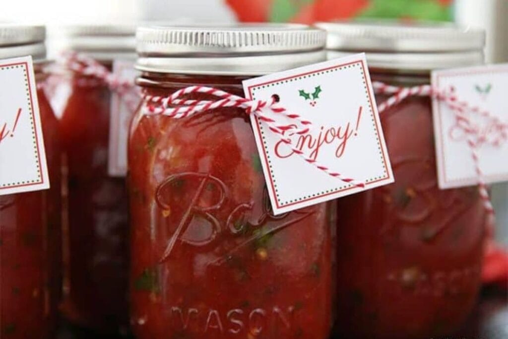 A close up shot of homemade salsa in a jar.