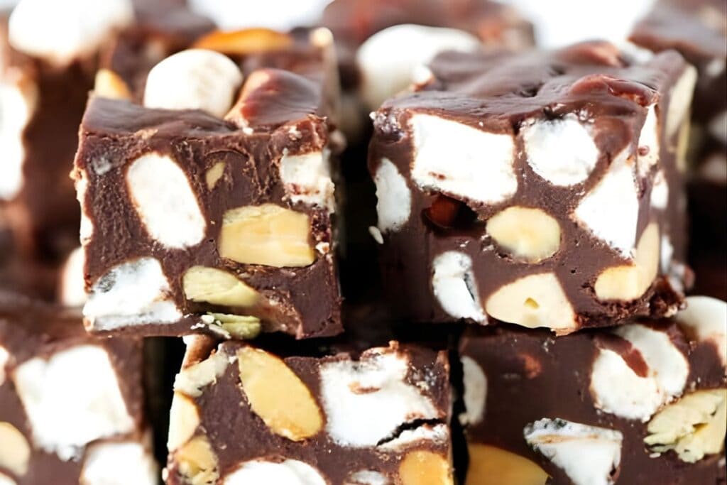 Close-up of rocky road fudge squares with marshmallows and nuts.
