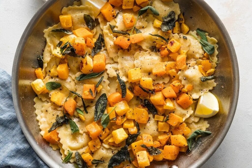 Bowl of brown butter ravioli with butternut squash.
