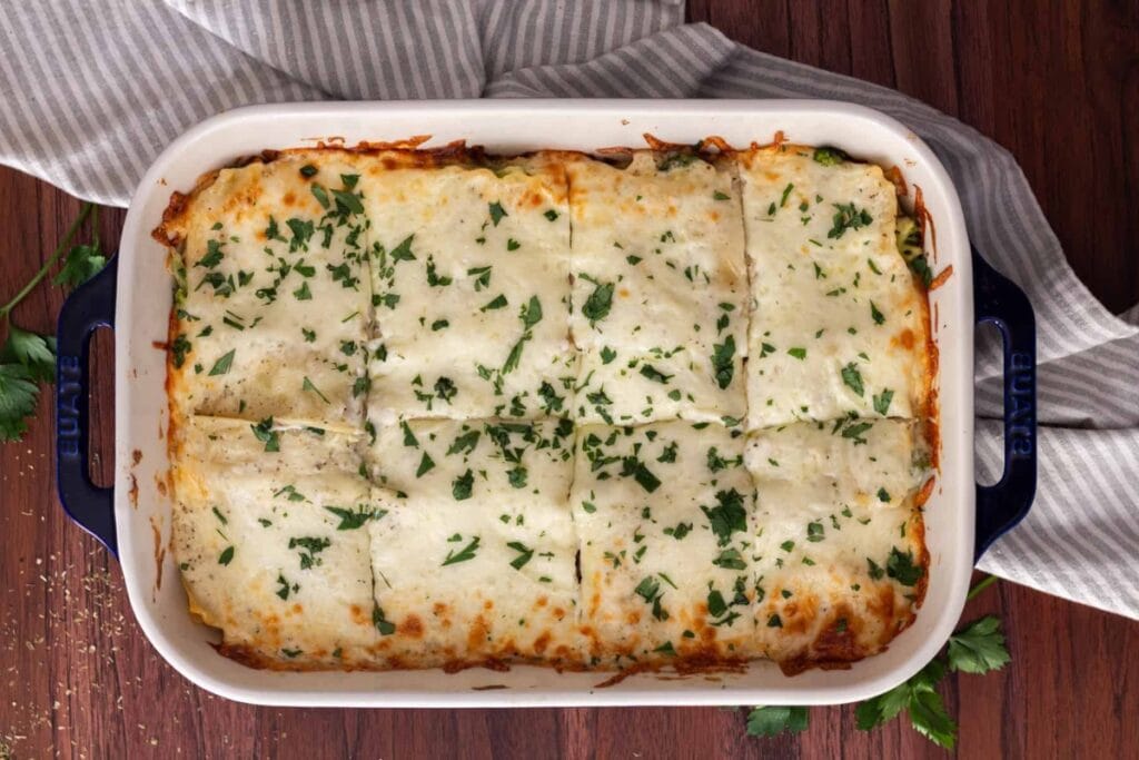 Cheesy chicken and broccoli lasagna in a baking dish.
