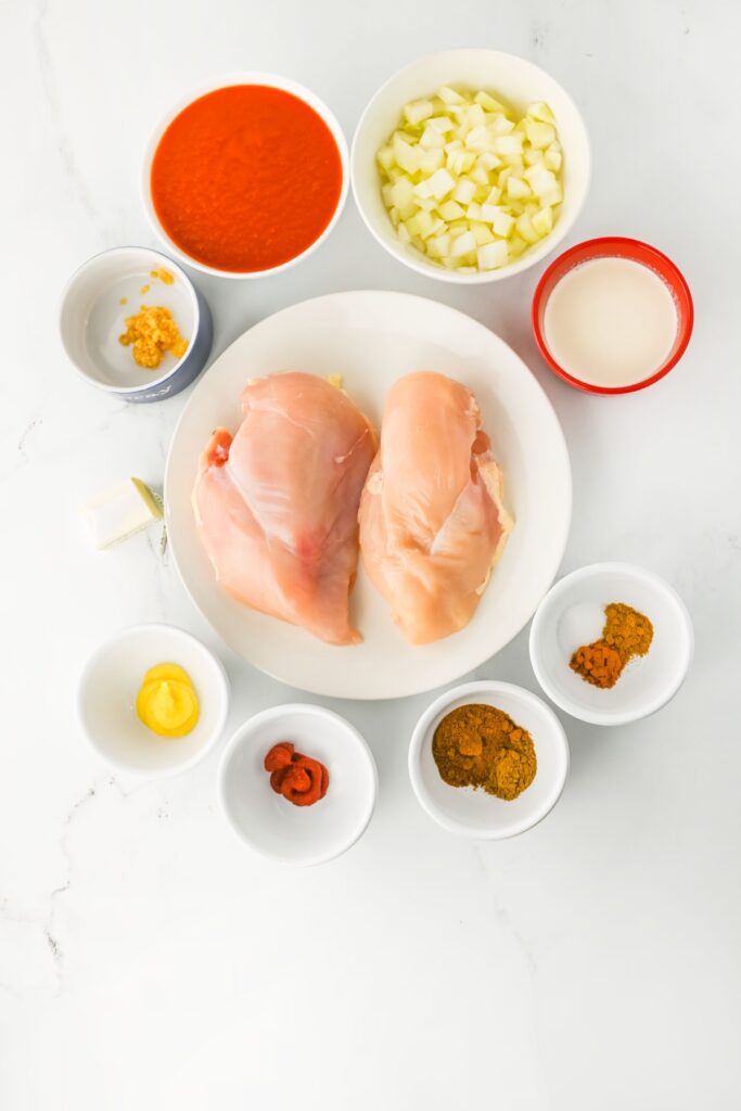 Ingredients for crockpot butter chicken arranged on a counter.