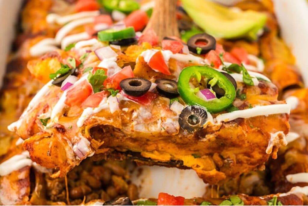 A close up shot of beef and bean enchiladas.