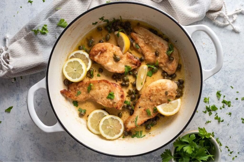 A close up shot of chicken piccata.