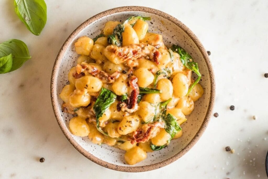 A close up shot of Cream tuscan Gnocchi.