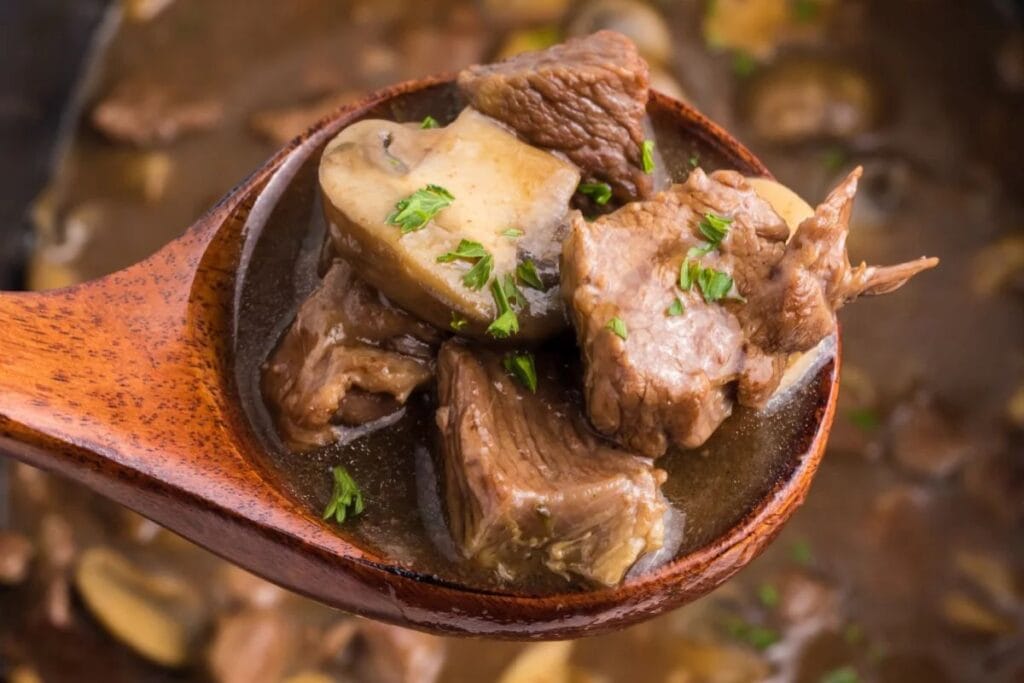A close up shot of crockpot beef tips and gravy.