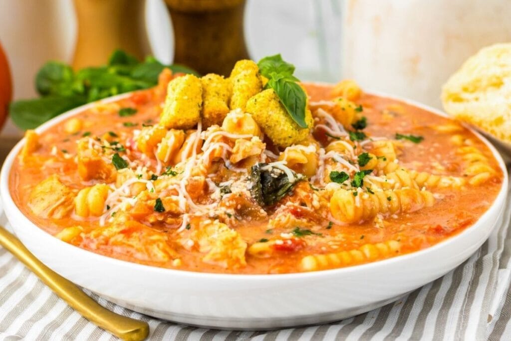 A close up shot of chicken parmesan soup.