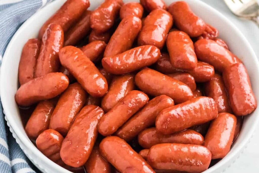 A close up shot of crockpot little smokies.