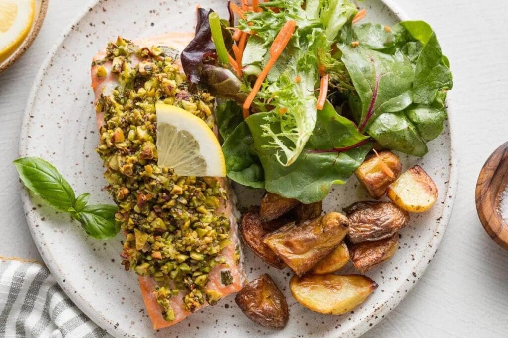 A close up shot of pan seared pistachio herb salmon.