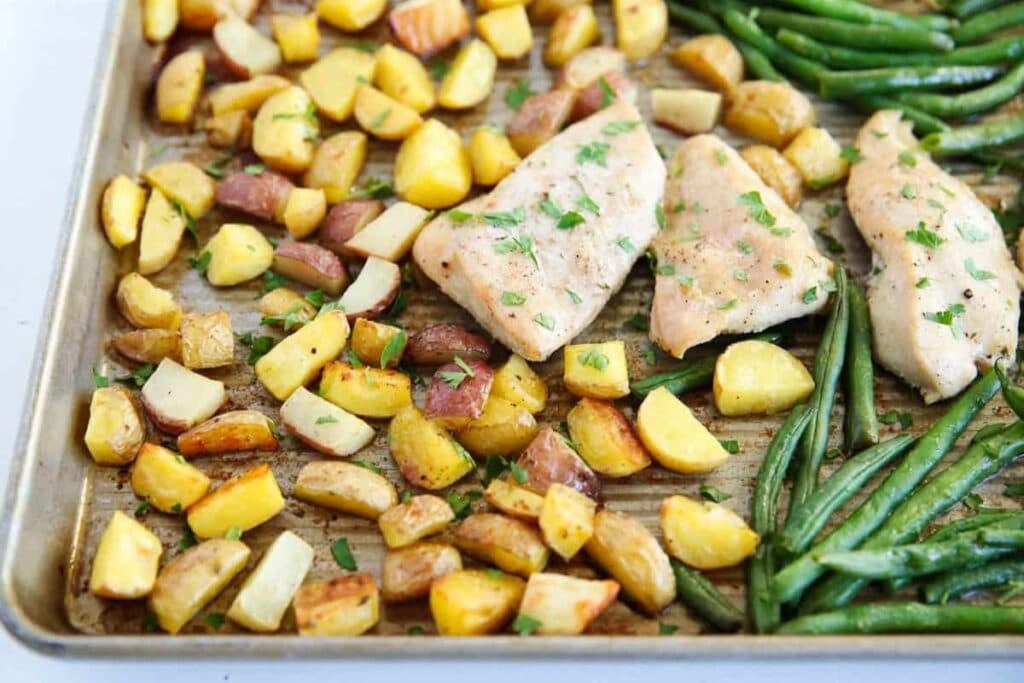 A close up shot of sheet pan chicken and potatoes.