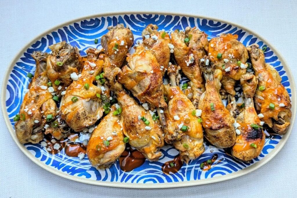 A close up shot of slow cooker buffalo chicken drumsticks.