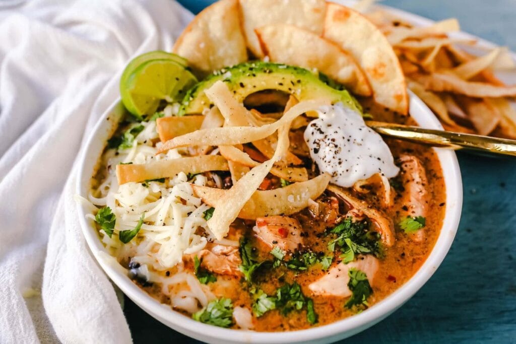 A close up shot of slow cooker creamy chicken tortilla soup.