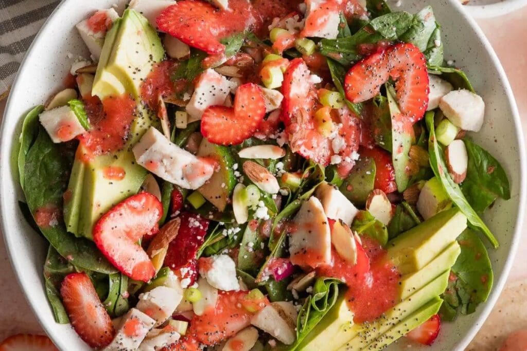 A close up shot Strawberry Spinach Salad with Chicken