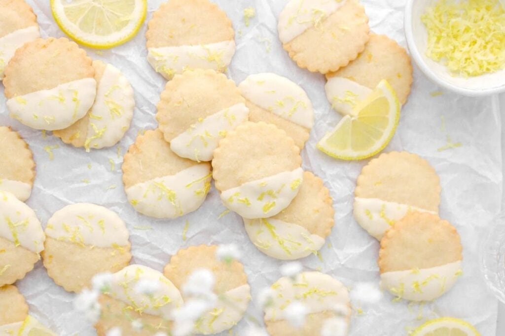 A close up shot of White chocolate dipped lemon shortbread cookies.