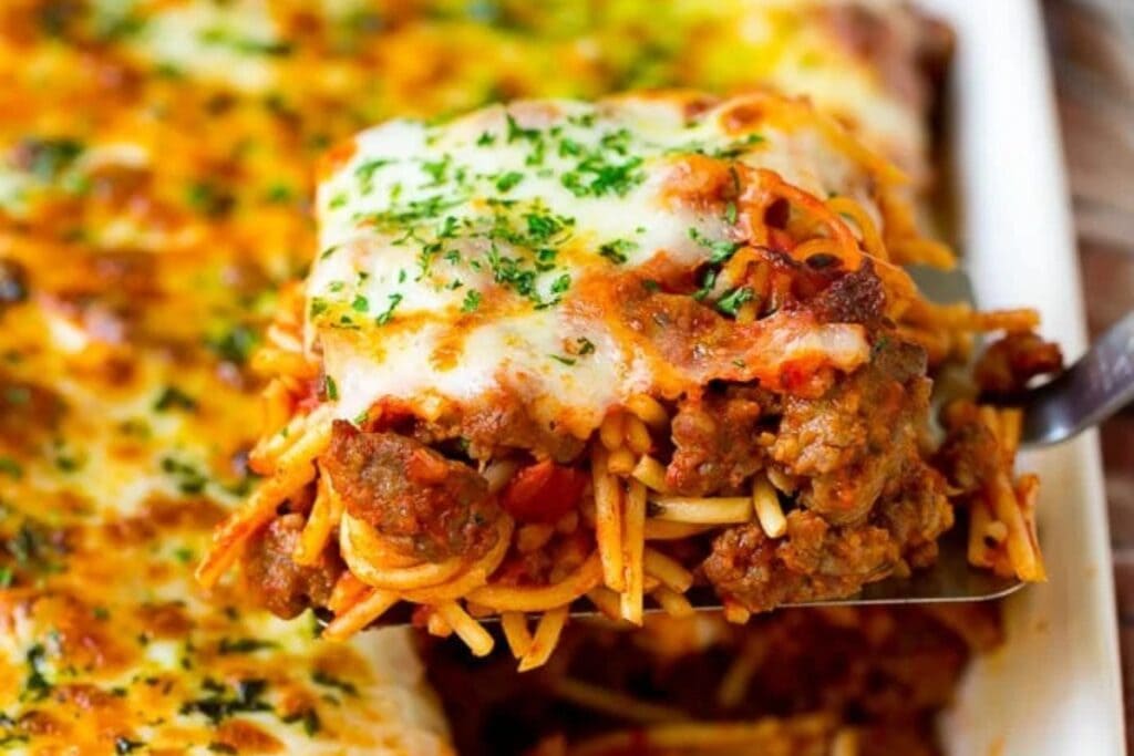 Close-up of baked spaghetti casserole on a spatula.