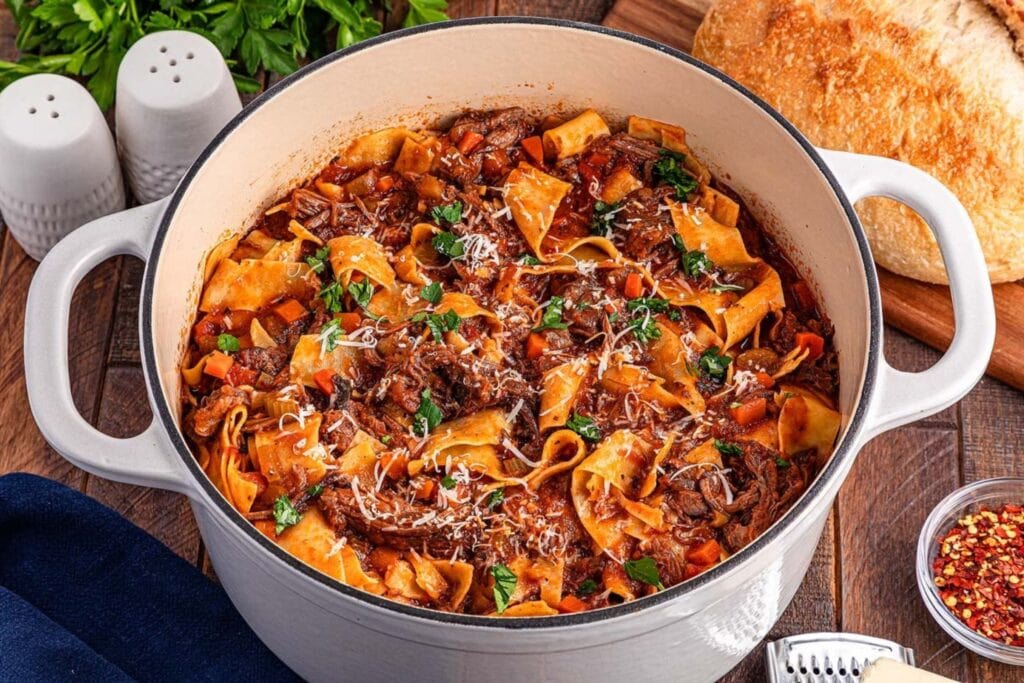 Beef short rib ragu with pasta in a pot.