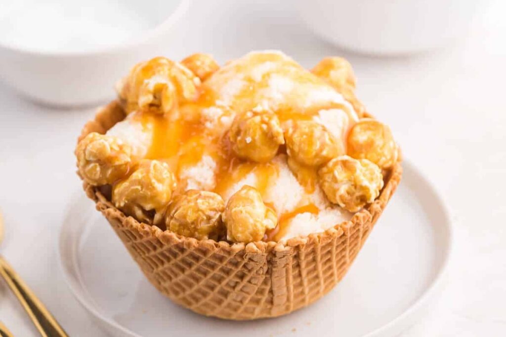 Caramel crunch ice cream sundae on a plate.