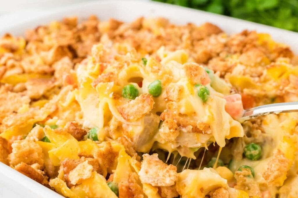 Close-up of chicken and noodle casserole on a spoon.