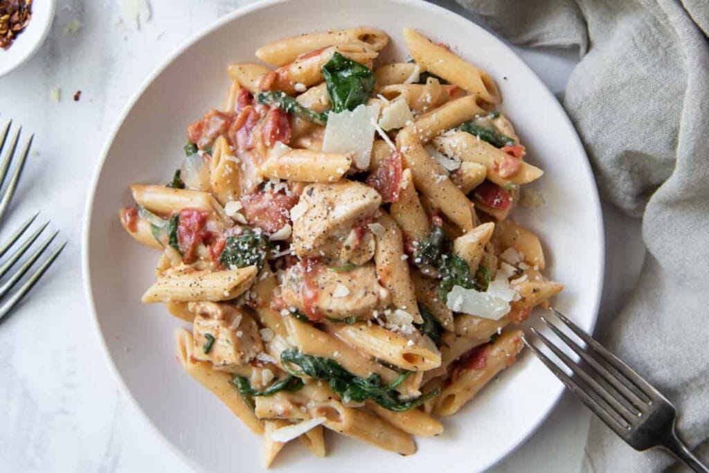 Chicken and spinach skillet pasta on a plate.