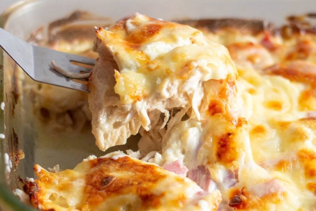 Chicken cordon bleu casserole in a glass baking dish.