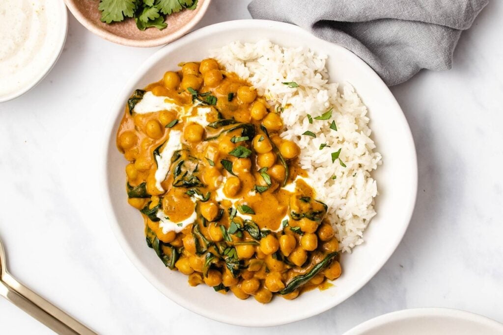 Chickpea spinach curry on a plate with rice.