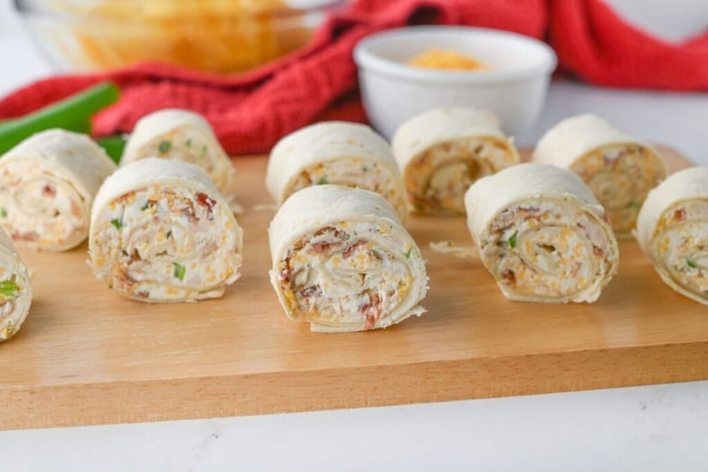 Crack chicken pinwheels on a wooden board.