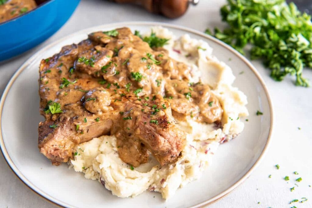 Cream of mushroom pork chops on a plate.
