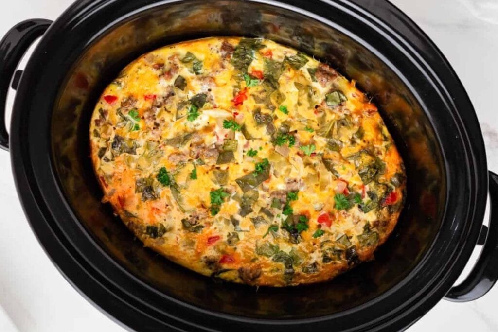 Crockpot breakfast casserole with eggs and vegetables in a slow cooker.