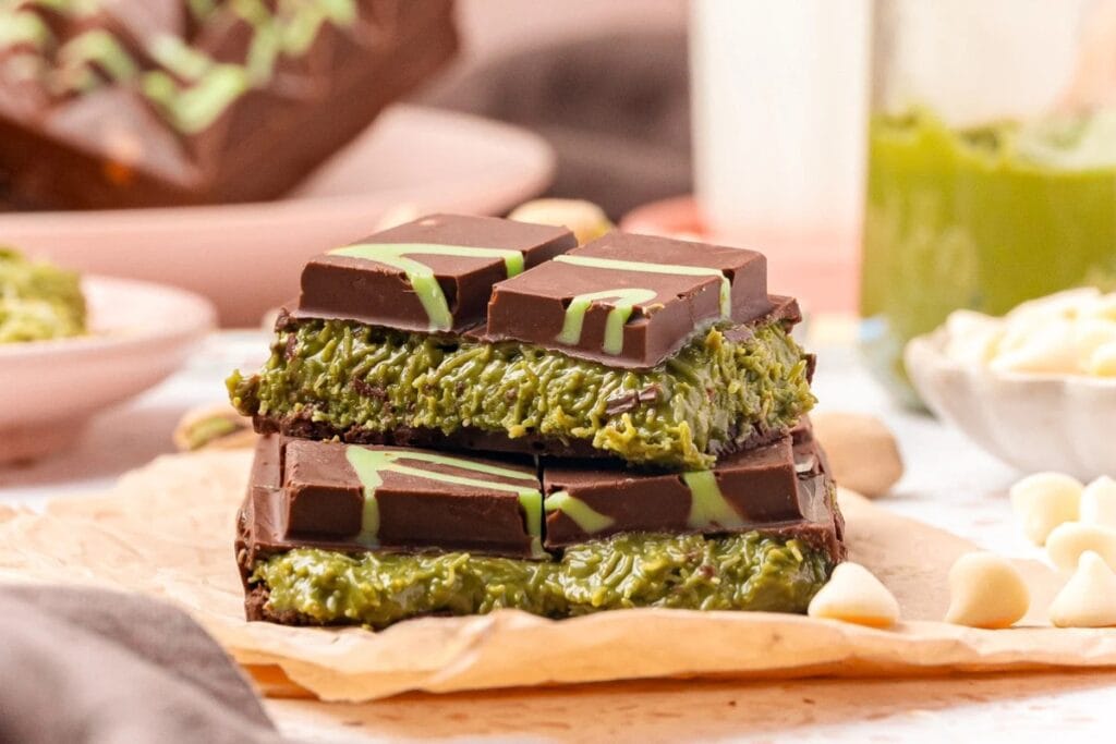 Close-up of Dubai chocolate bars with pistachio filling on parchment paper.