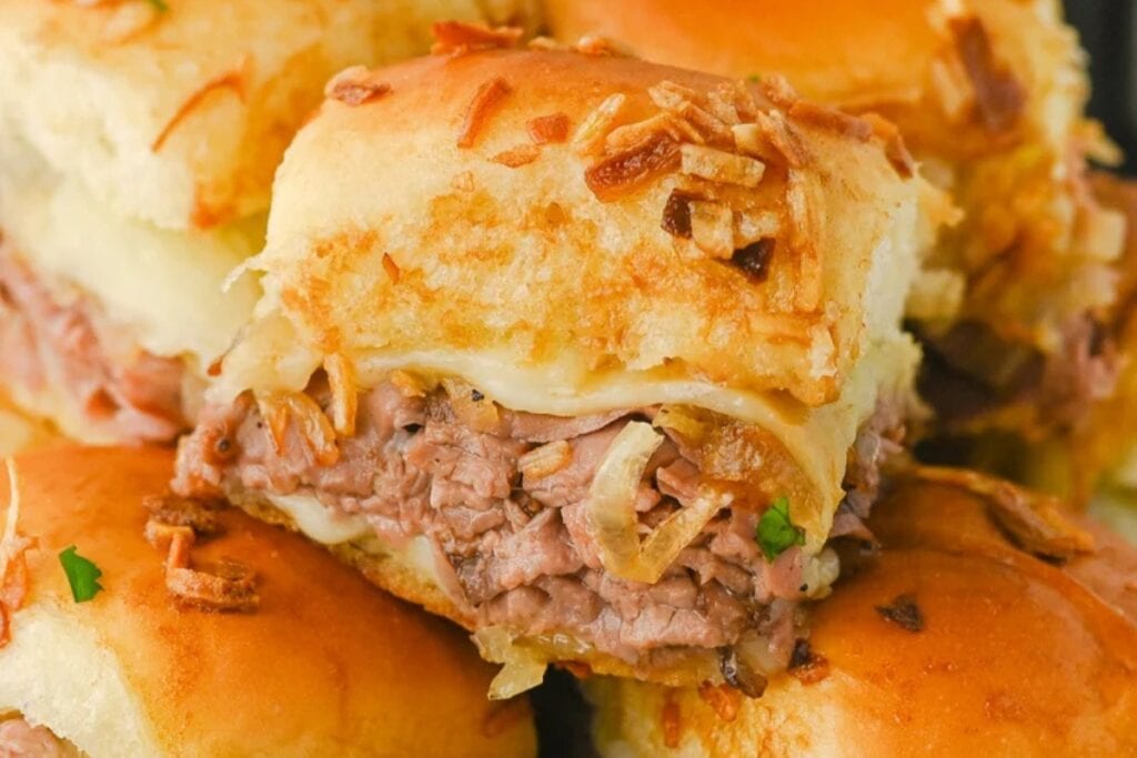 Close-up of French dip sliders with au jus.