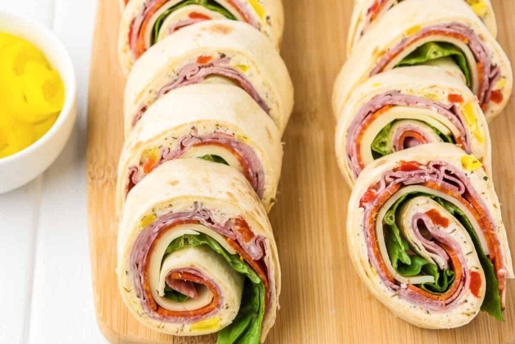 Italian pinwheels on a wooden board.