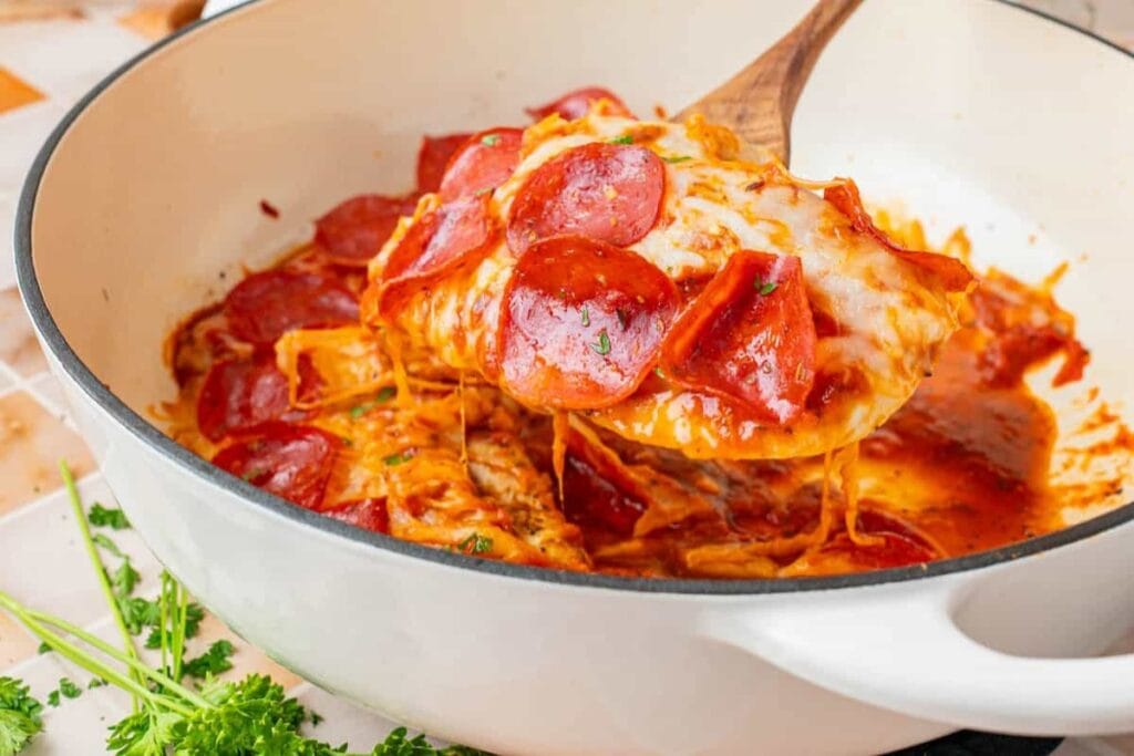 Close-up of low carb pizza chicken on a wooden spatula.