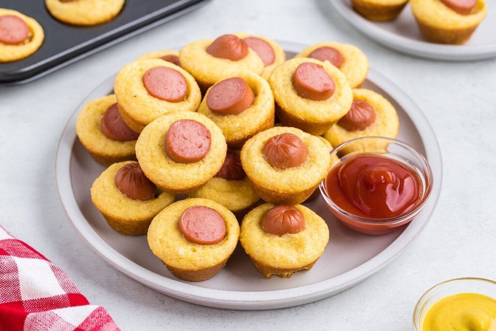 Mini corn dog muffins on a plate.